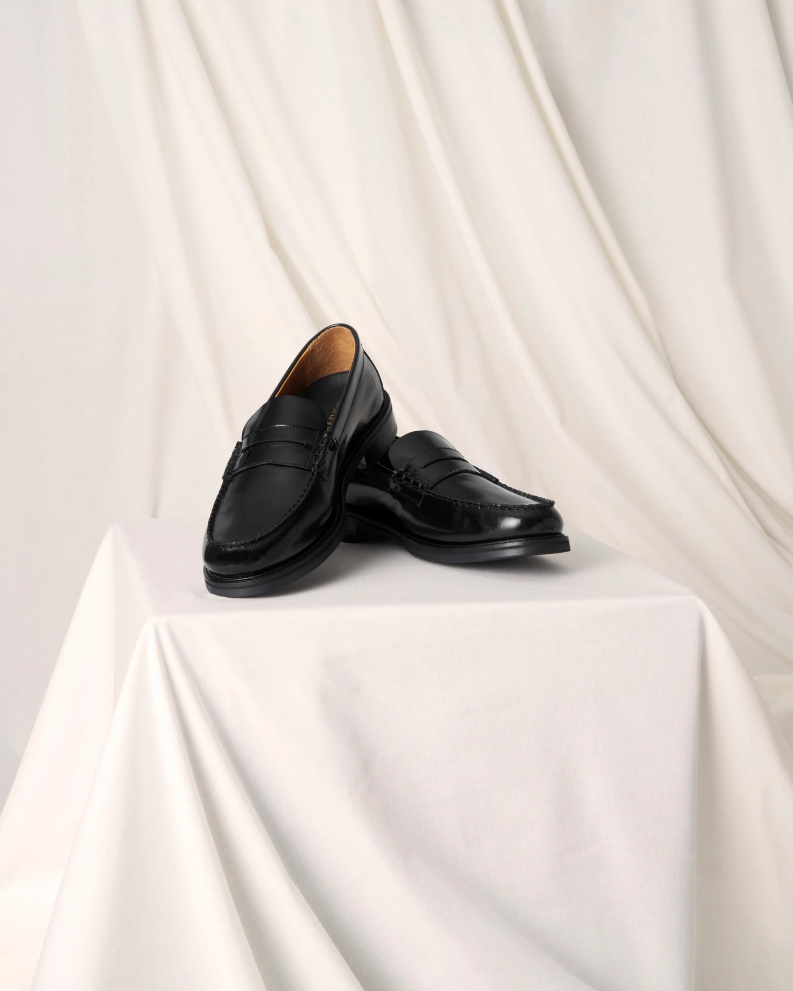 Black leather penny loafers for men and women